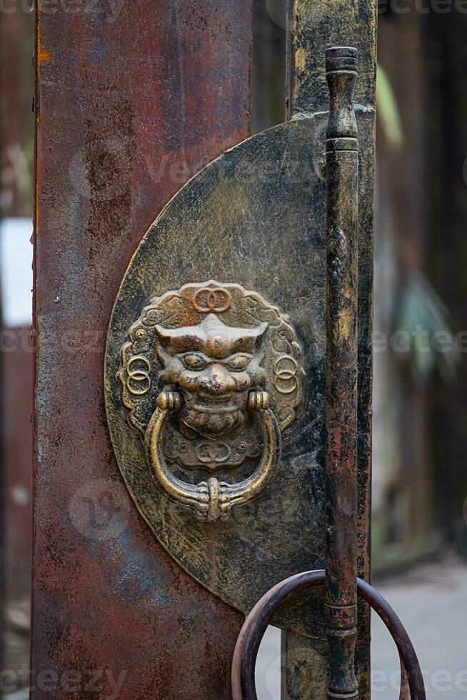 Dragon head door knocker, close up. Antique Chinese handle knocker. photo