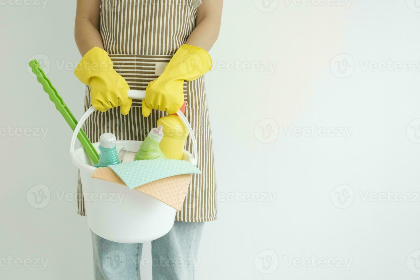 Young woman holding cleaning equipments ready for cleaning. photo