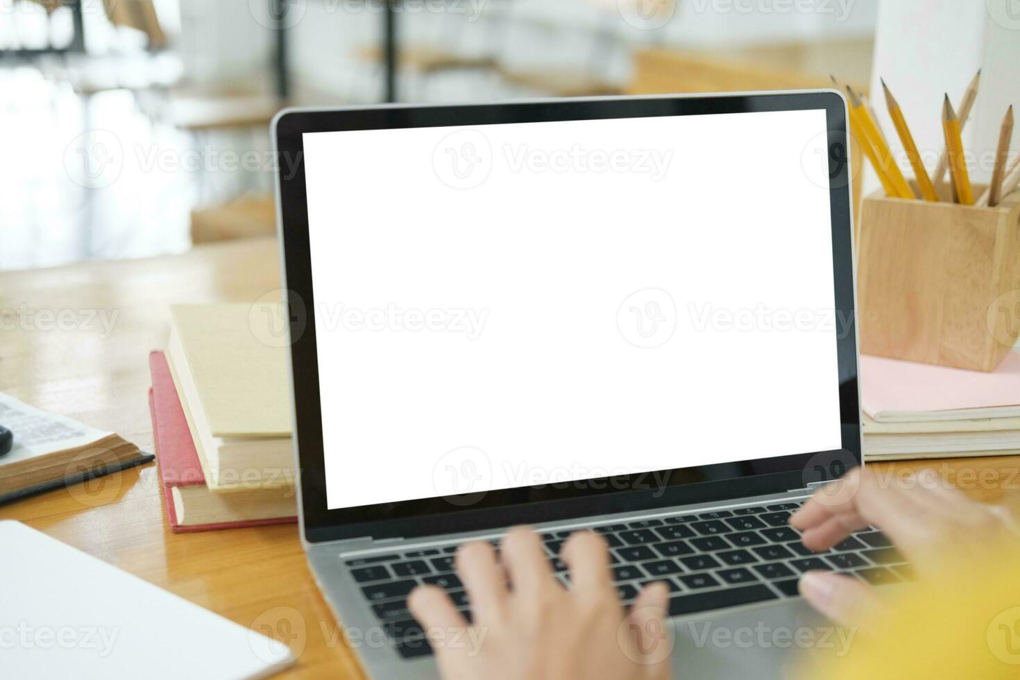 Close up of woman studying online using laptop with blank screen. photo