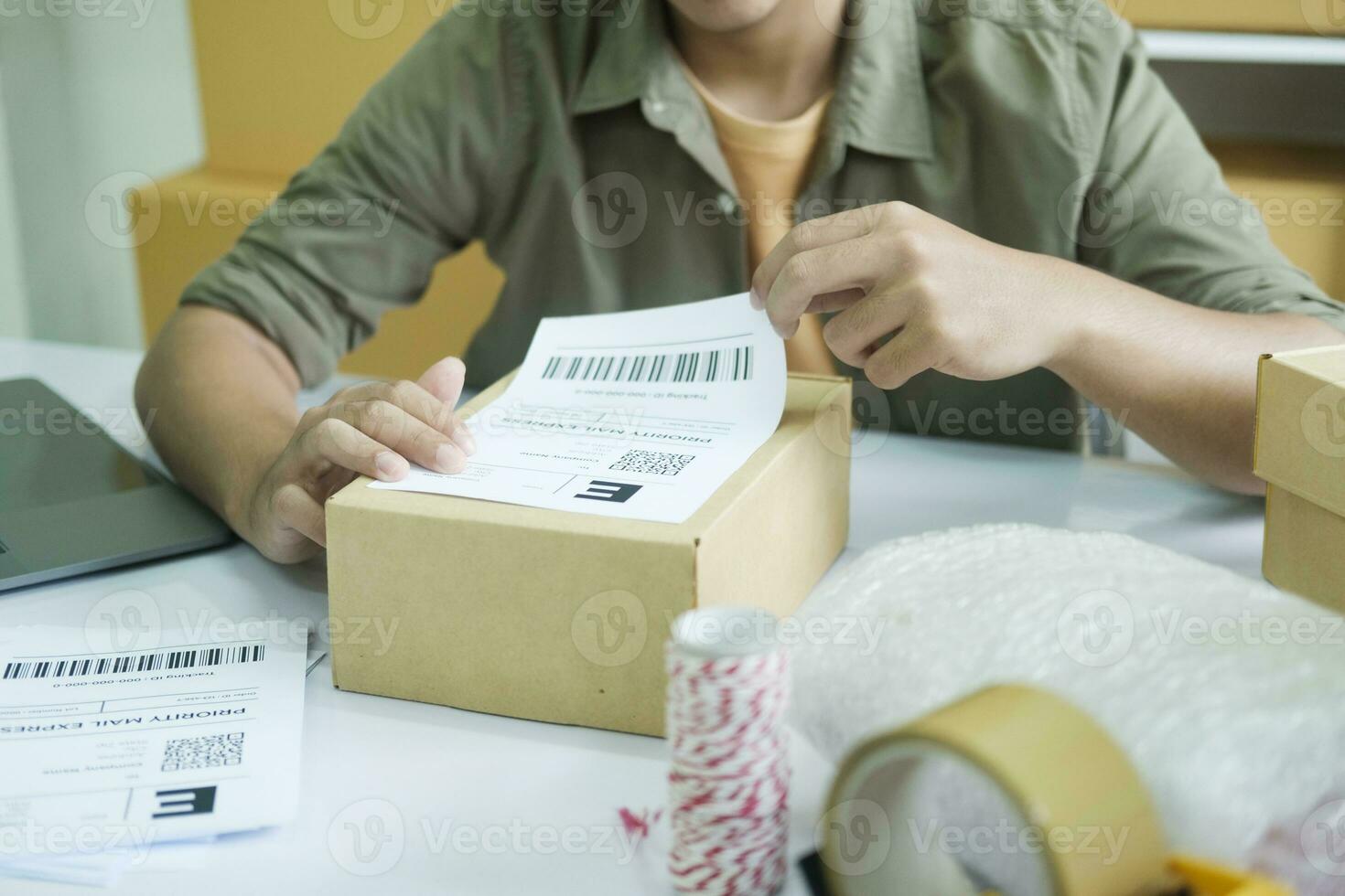 Young entrepreneur packing online order product for shipping. photo