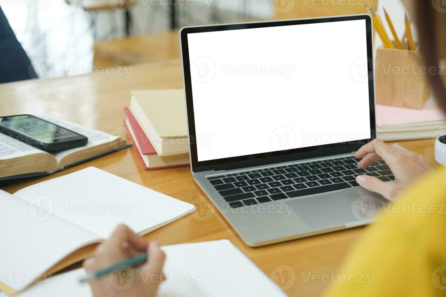 Close up of woman studying online using laptop with blank screen. photo