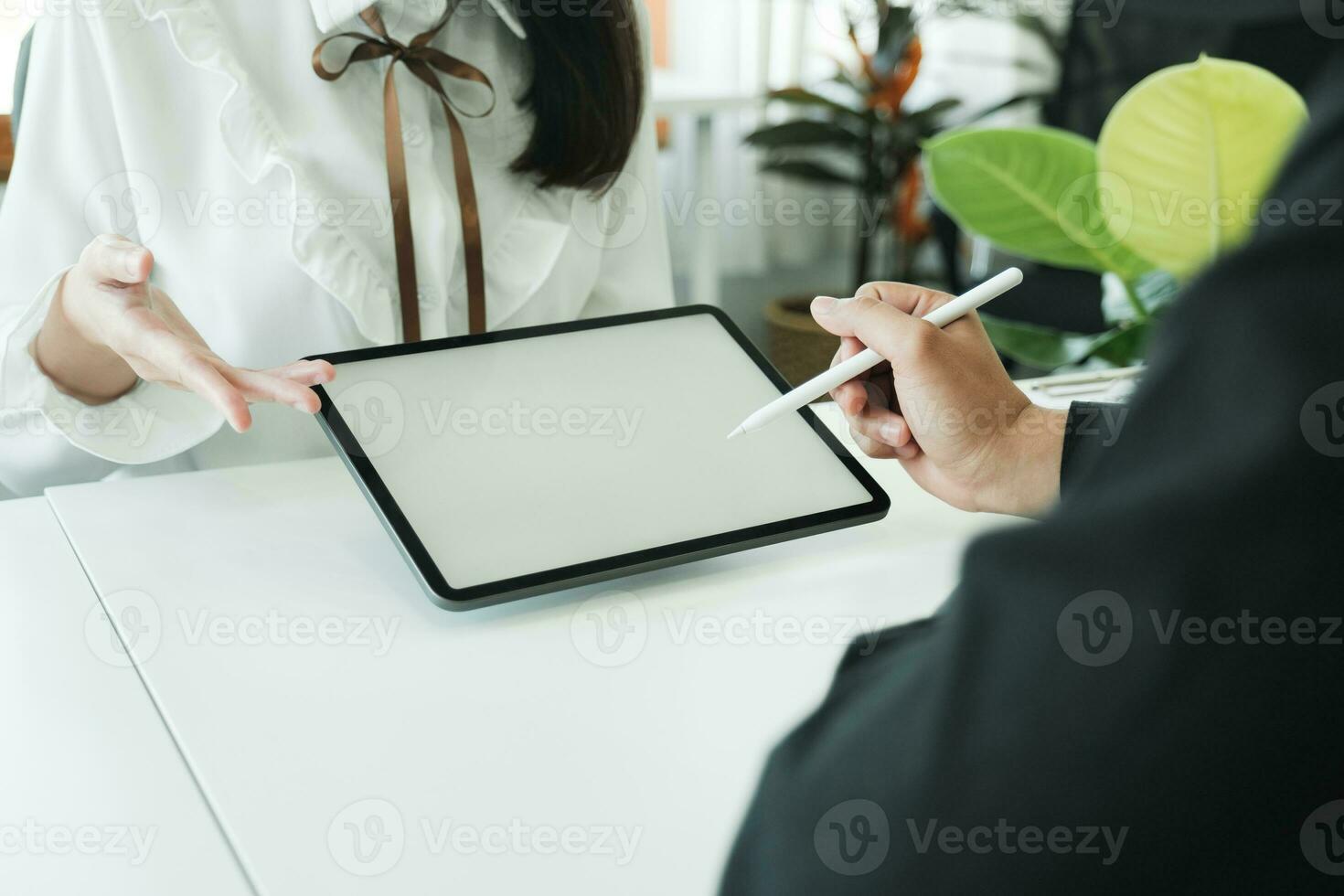 Businessman teamwork meeting and discussing on with mock-up tablet using stylus pen. photo