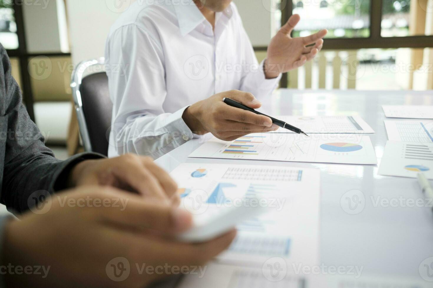 Asisan businessman teamwork meeting and discussing the investment data and report graph. photo