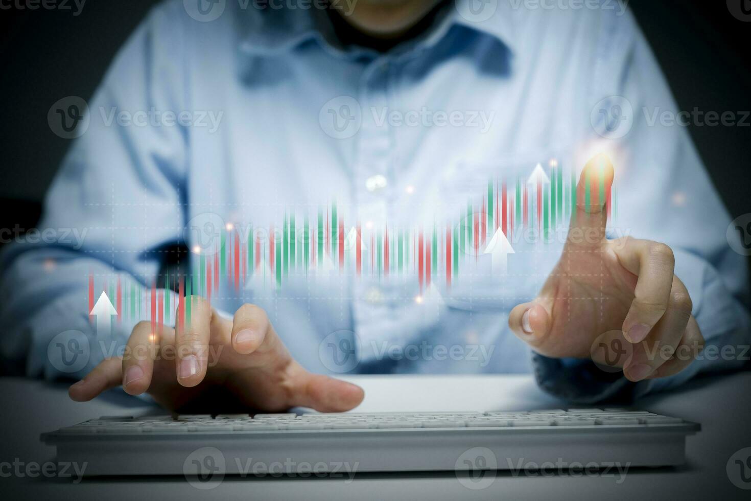Man typing and pointing to holographic trading chart. photo