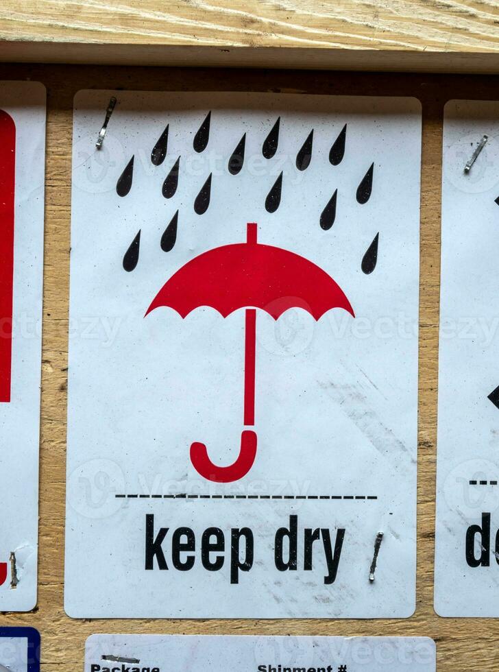 Keep-dry symbol information label beside transportation wooden box photo