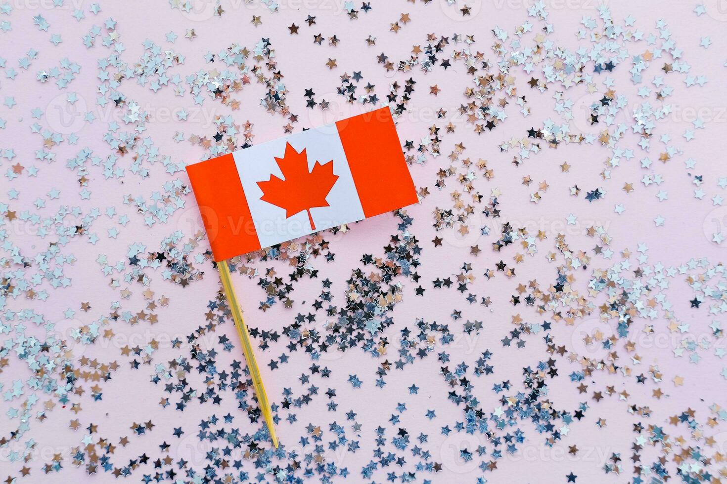 Canada flag and sparkles on pink background, flat lay. Holiday in Canada. 1th of July, Canada's Happy Independence Day. photo