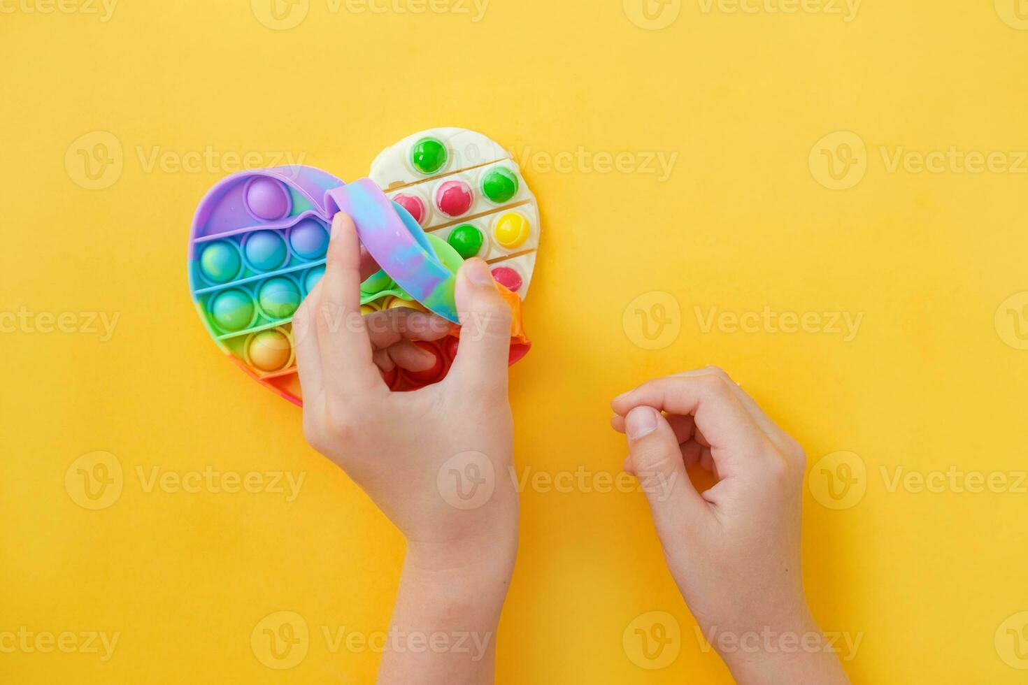 Children's hands take out the prepared chocolate with their own hands from the popit silicone mold. Use the popular pop it toy as a chocolate . DIY concept. Step-by-step photo instructions. Step 8.