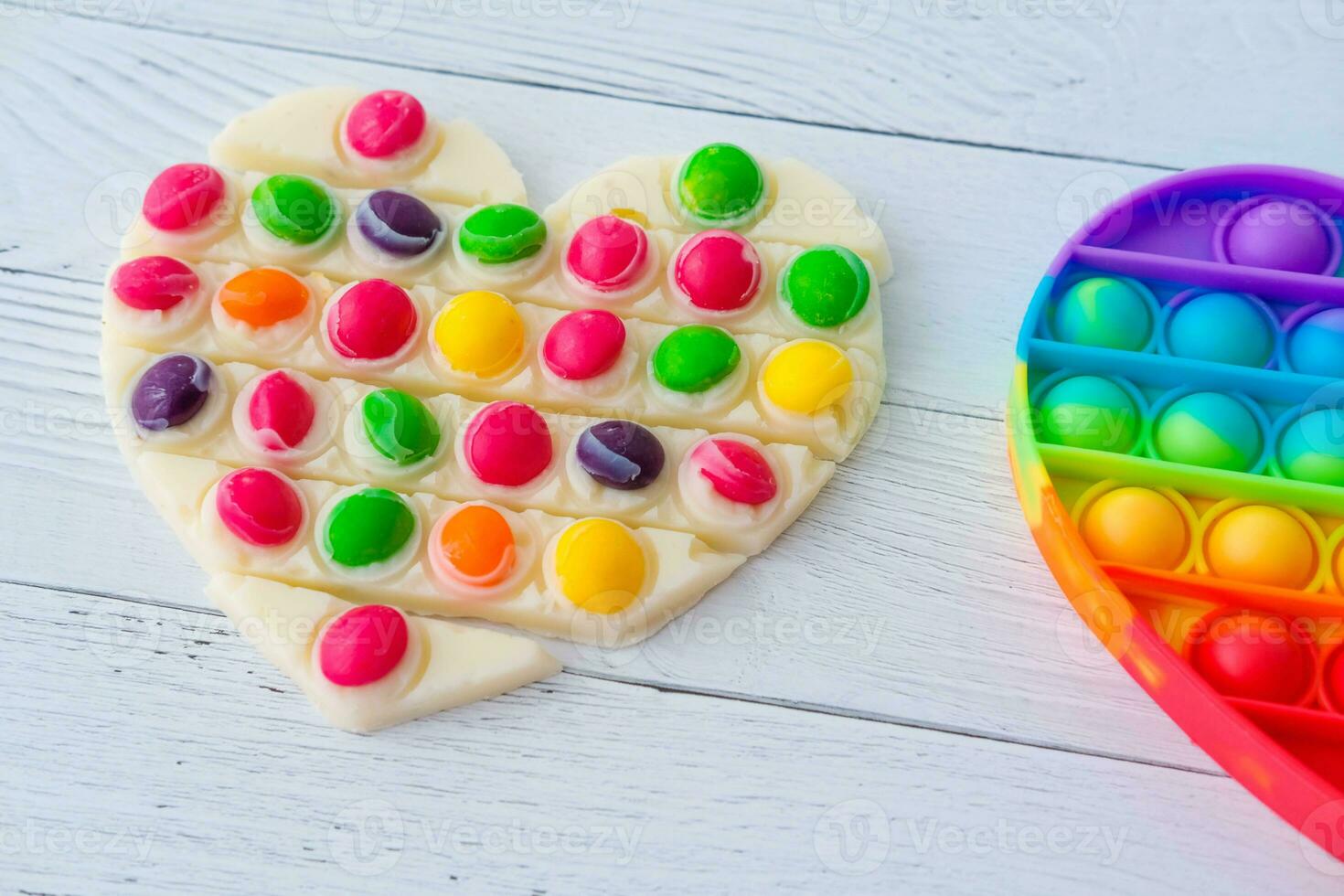 Use the popular pop it toy as a chocolate mold. White chocolate and colorful candies and popit silicone toy. DIY concept. Step-by-step photo instructions. Step 10.