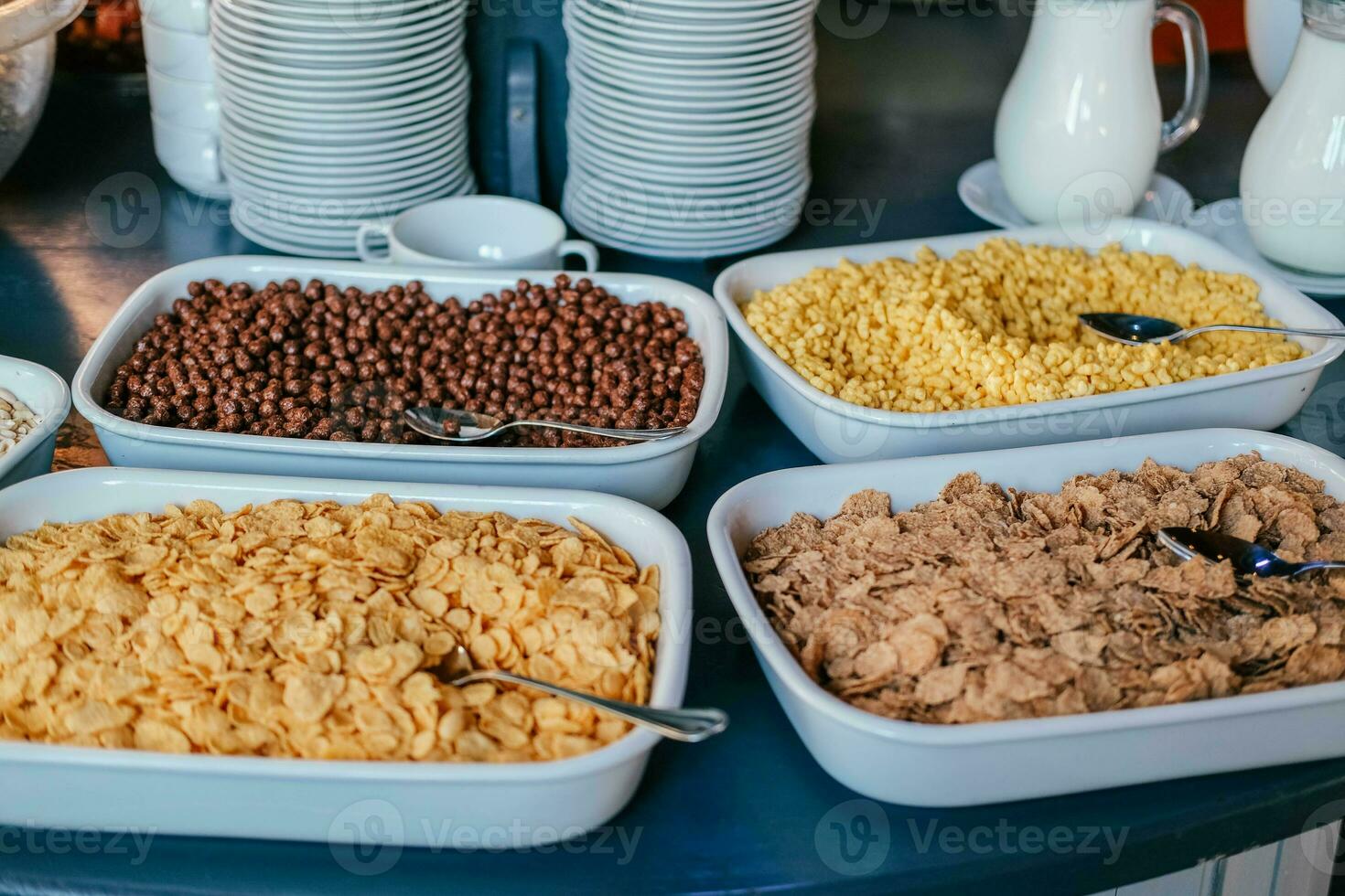 Cereal in big bowls for self service dry quick breakfast food in hotel restaurant selection . Buffet display, catering for brunch filled delicious food assortment. photo