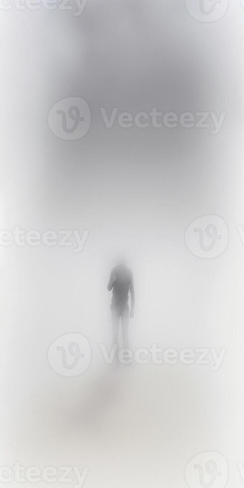 there is a man walking in the fog with an umbrella. . photo