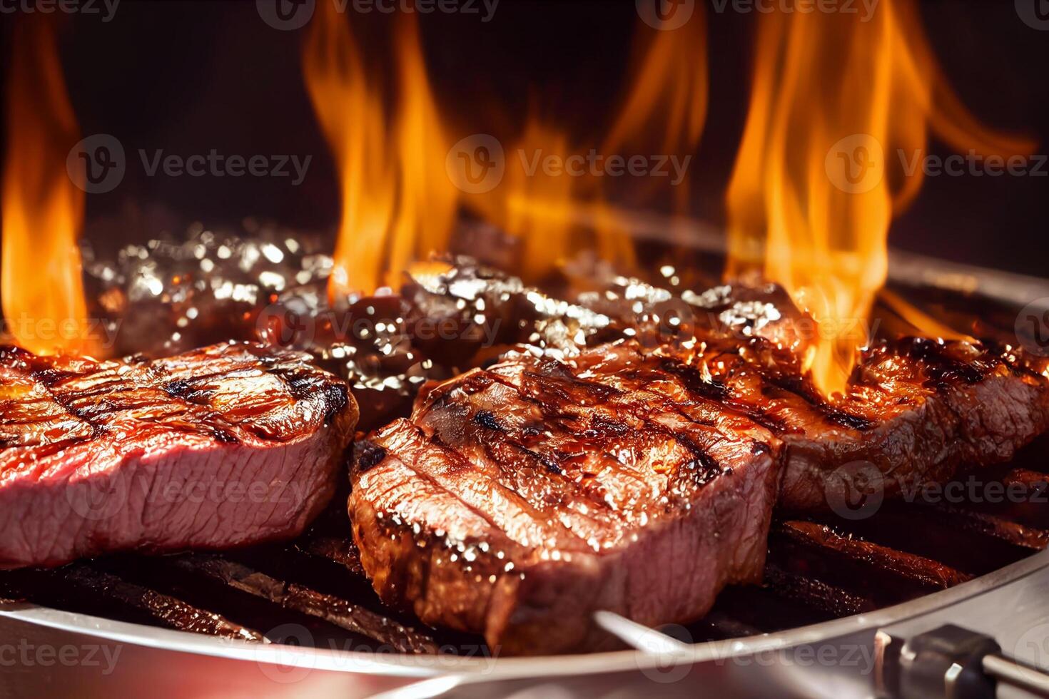 Grilled meat steak on stainless grill depot with flames on dark background. Food and cuisine concept. photo