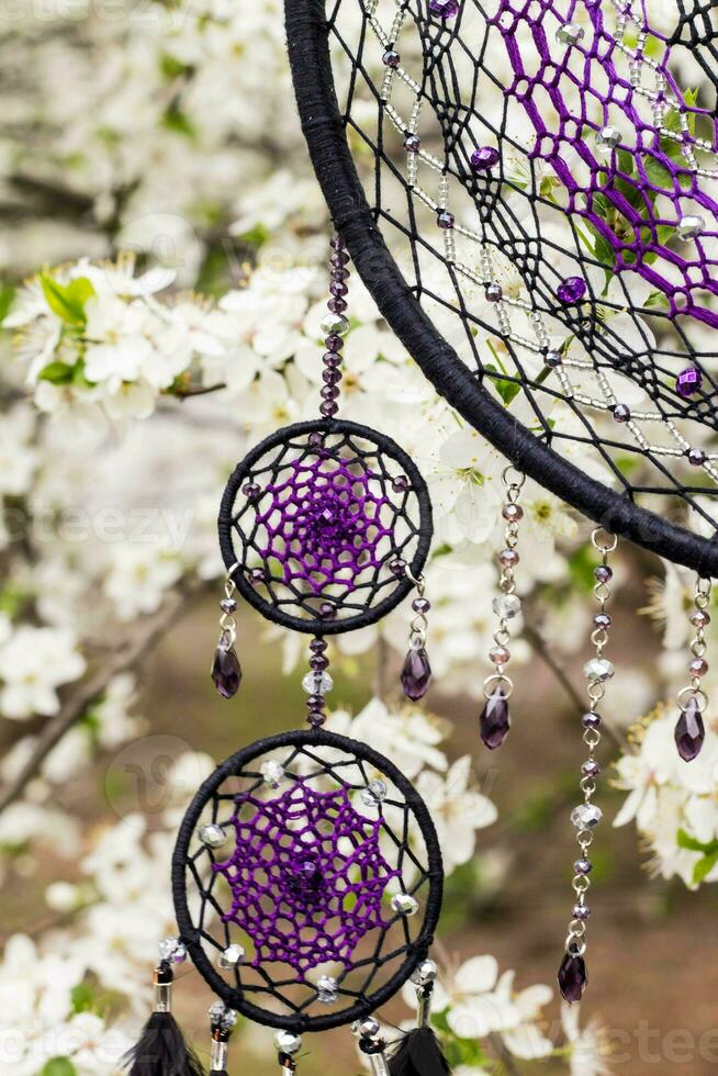 Handmade dream catcher with feathers threads and beads rope hanging photo