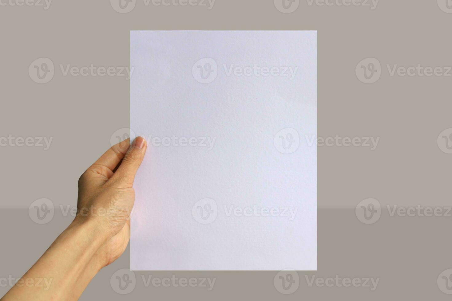 Realistic hand holding US letter paper mockup. Portrait US letter size mockup. Simple, clean, modern, minimal poster mock up. Paper mockup in hand photo