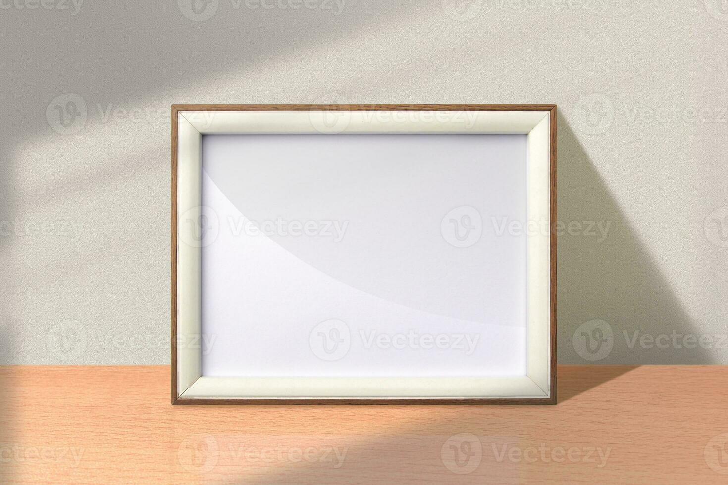 Small landscape photo frame mockup. Wooden frame mockup on the table with shadow overlay effect. Simple, clean, modern, minimal empty poster frame mock up. White picture frame mockup