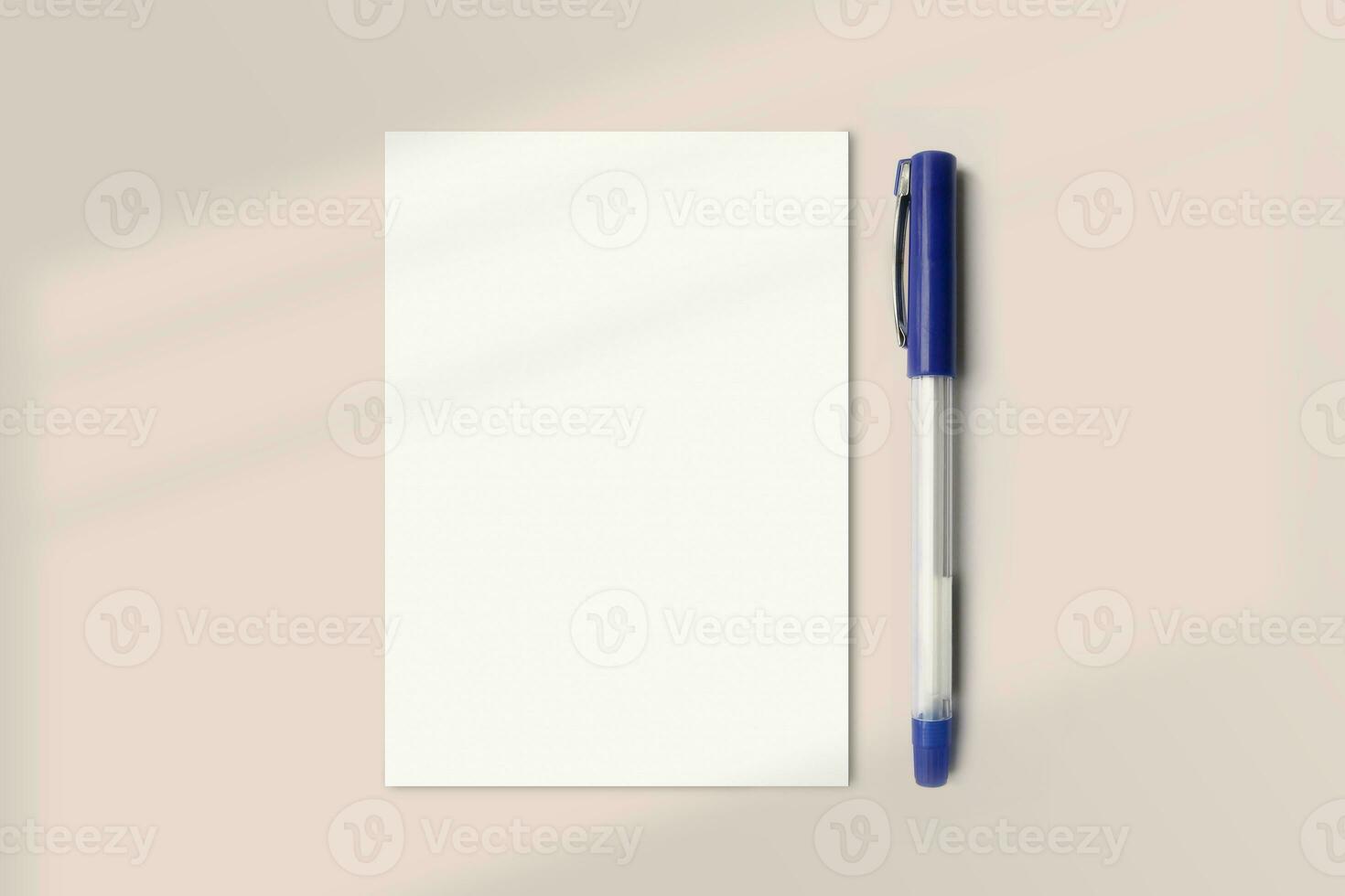 Realistic A6 paper flatlay mockup with a pen. Portrait A6 International Paper Size mockup top view. Simple, clean, modern, minimal small paper mock up flat lay concept photo