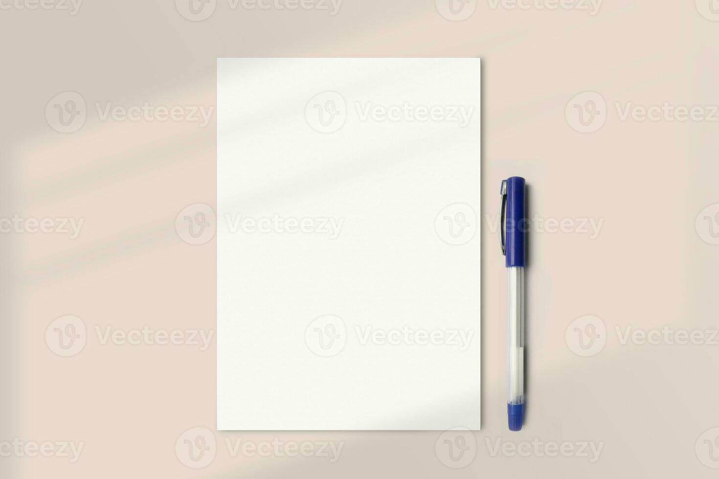 Realistic A5 paper flatlay mockup with a pen. Portrait A5 International Paper Size mockup top view. Simple, clean, modern, minimal small paper mock up flat lay concept photo