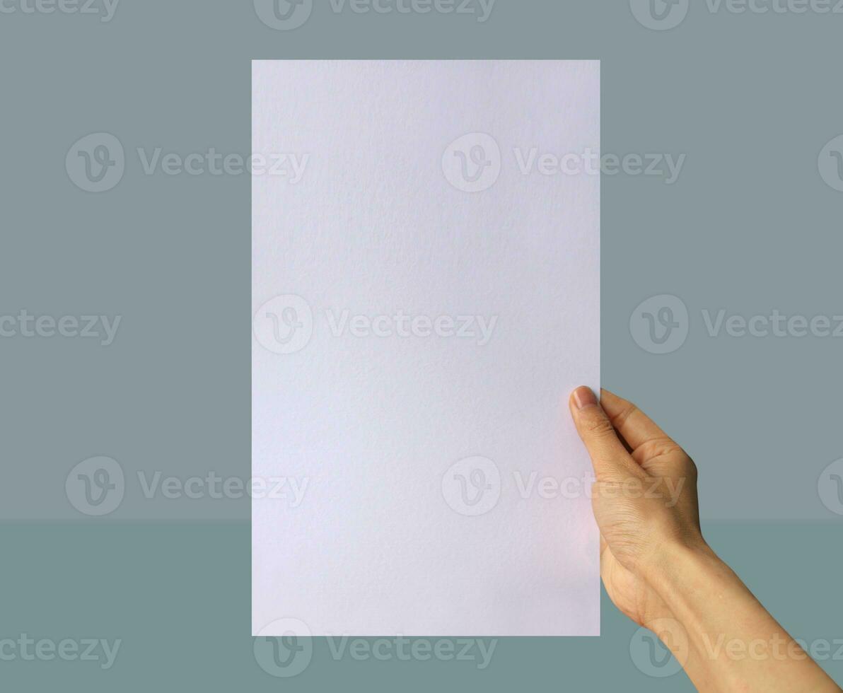 Realistic hand holding US legal paper mockup. Portrait US legal size mockup. Simple, clean, modern, minimal poster mock up. Paper mockup in hand photo