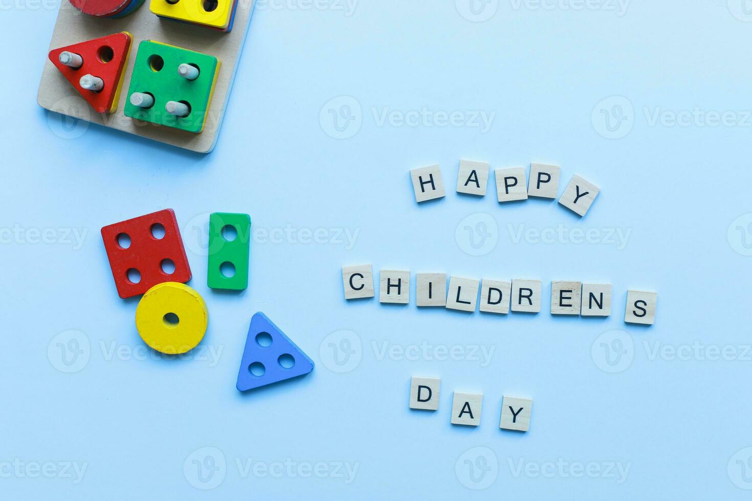 Flat lay happy children is day on blue background. Kids toys. Children is sorter. photo