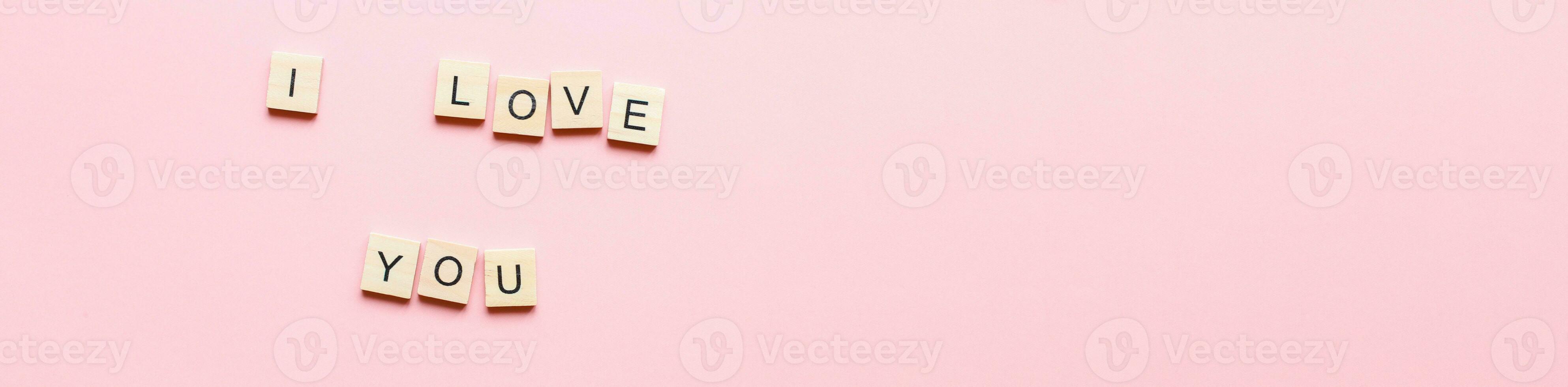 Banner I love you made of wooden letters on a pink background. Flatly i love you. Flat lay valentines day photo