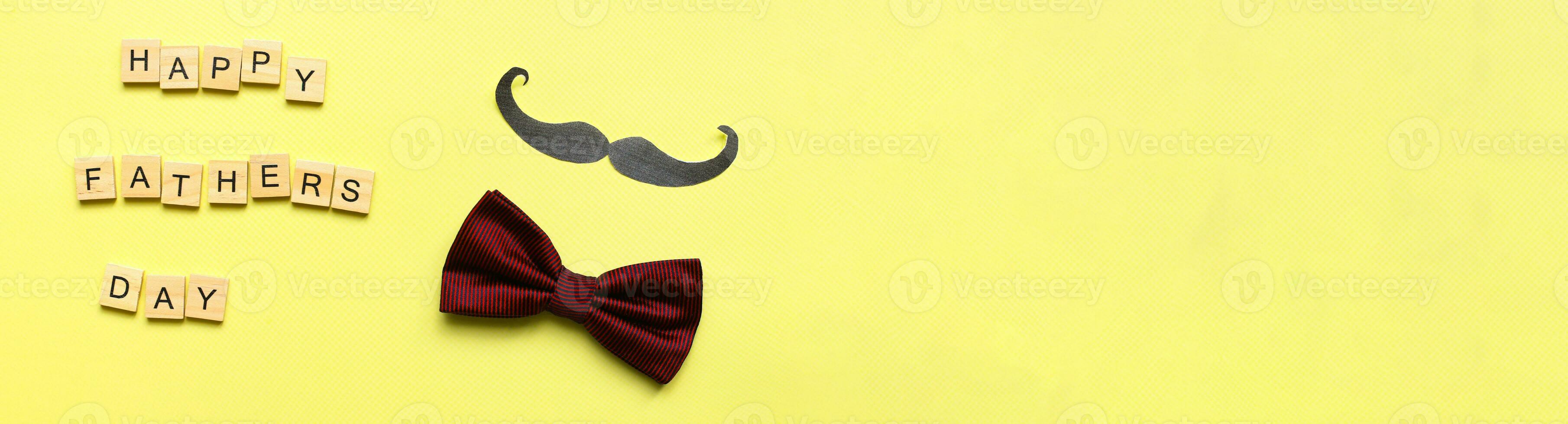 Banner Happy fathers day. Flat lay mustache. bow tie on a yellow background. Fathers day lettering word photo