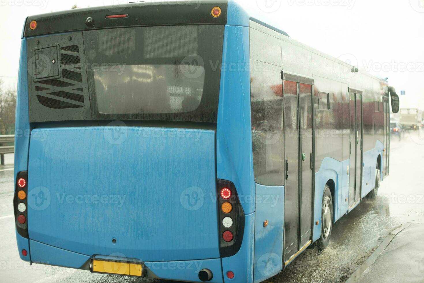 Bus on road. Blue bus pulls away from station. photo