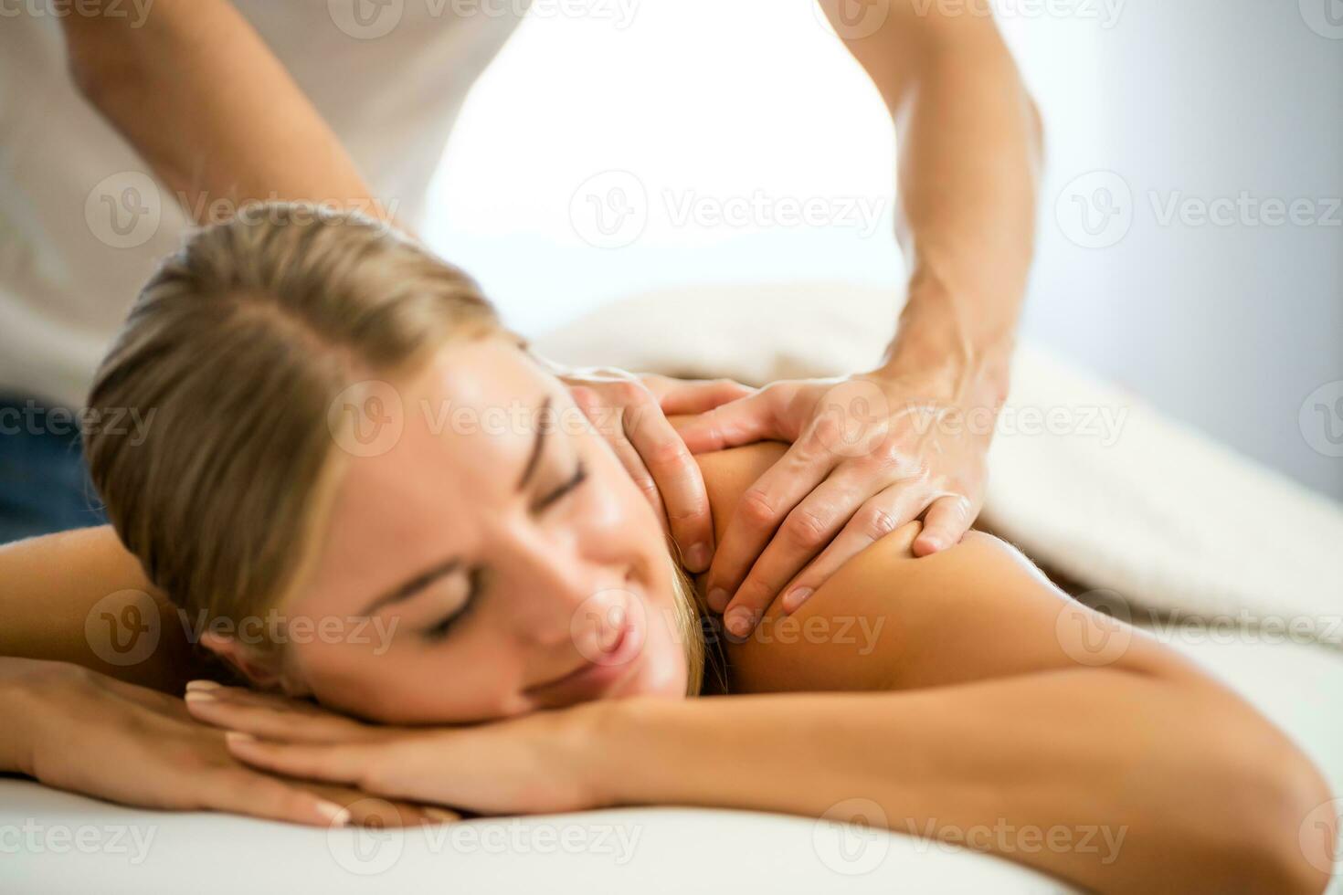 Woman enjoying a back massage photo