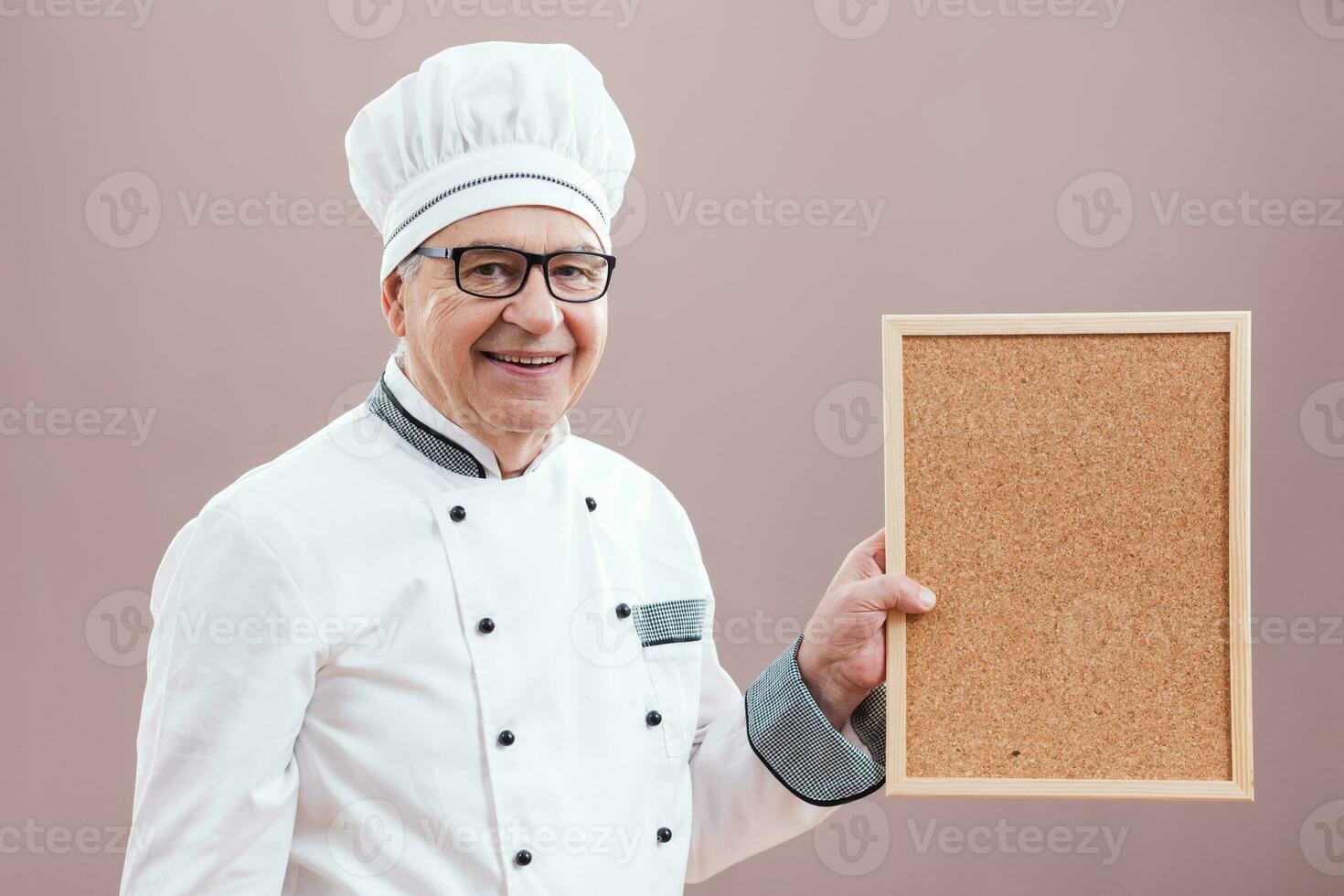 A chef pointing to a display photo