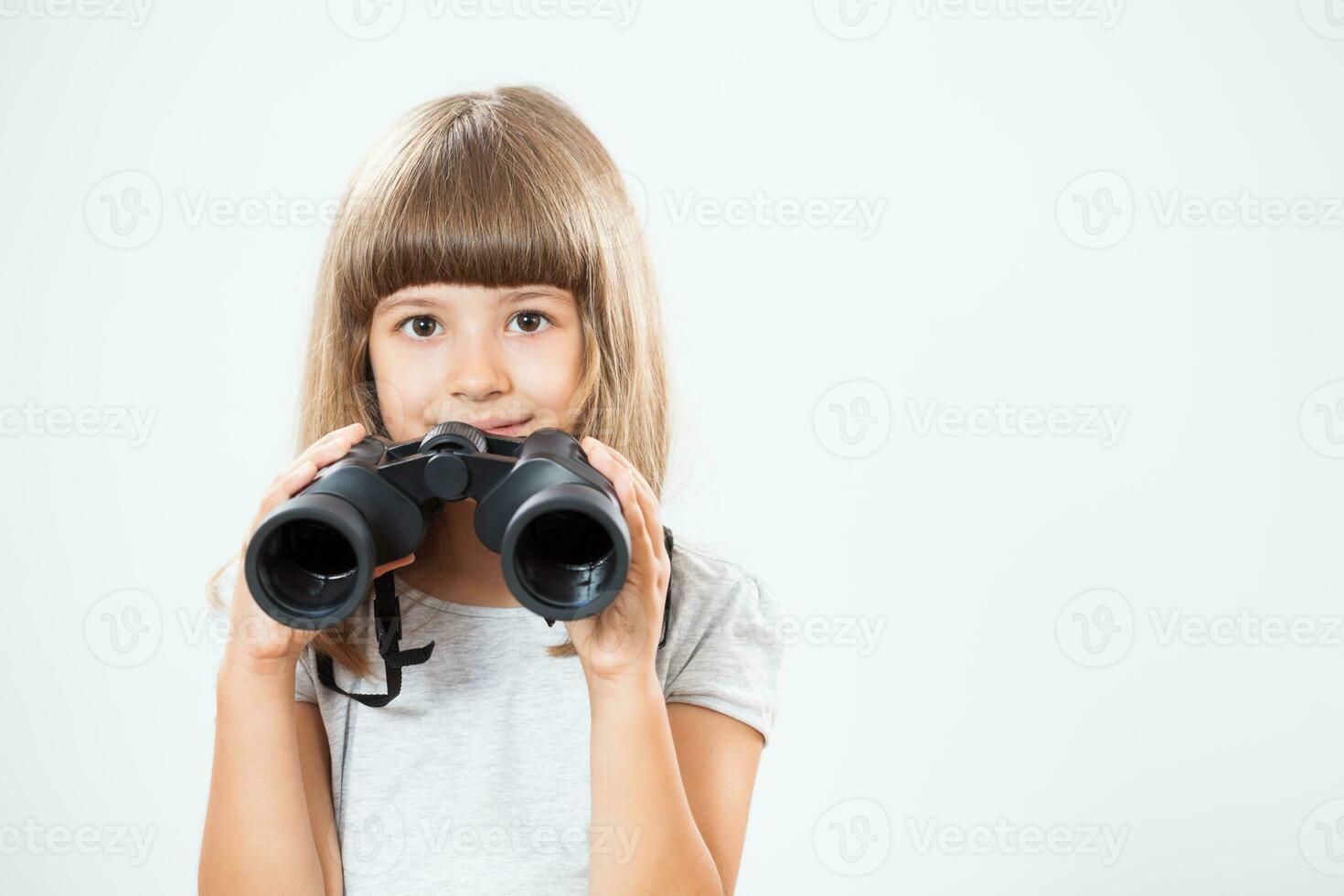 Portrait of a young girl with binoculars photo