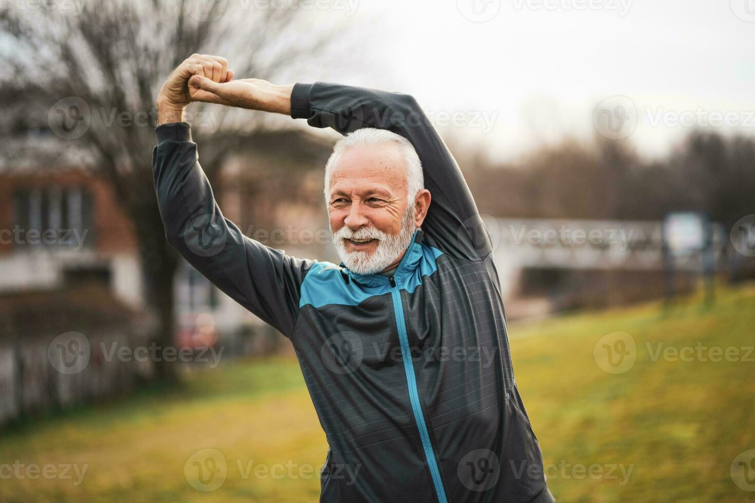 A senior man doing physical exercises photo