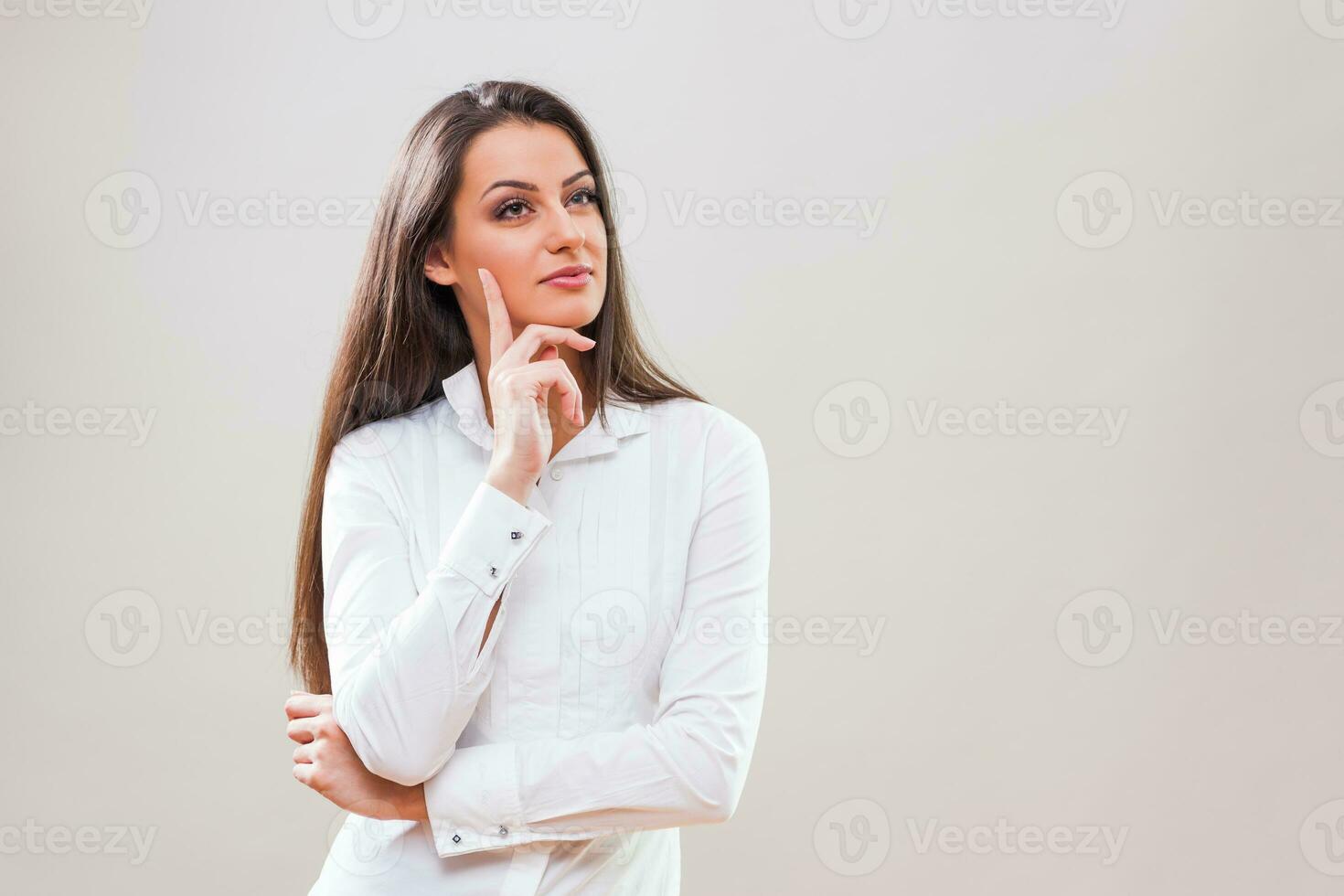 A pensive woman in a white shirt photo
