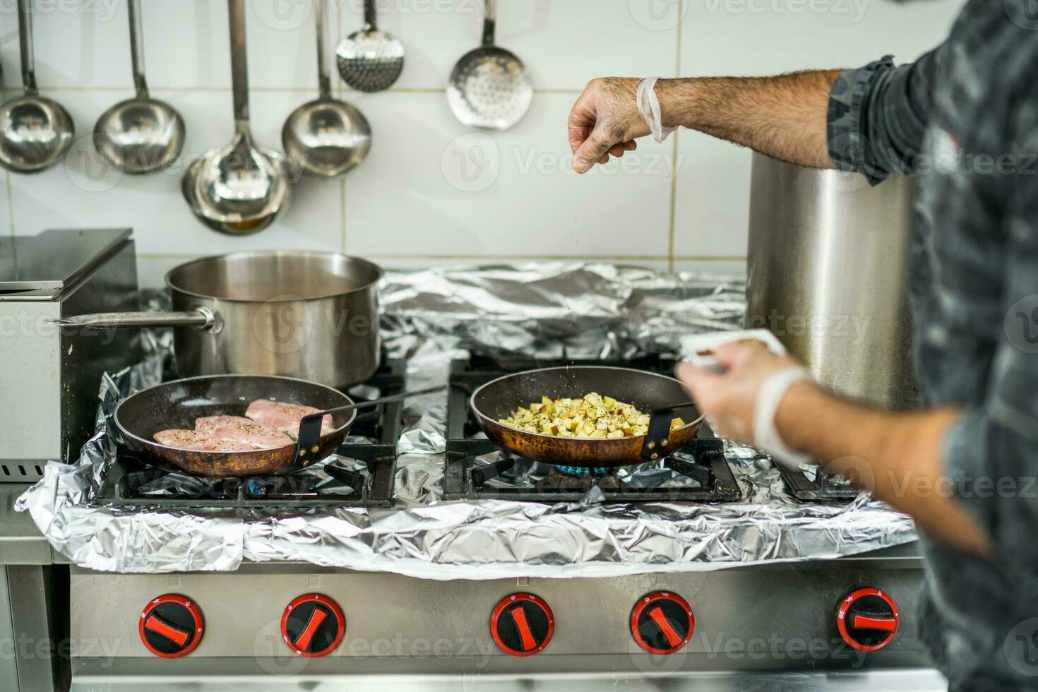 A chef is preparing a meal in the restaurant's kitchen. photo