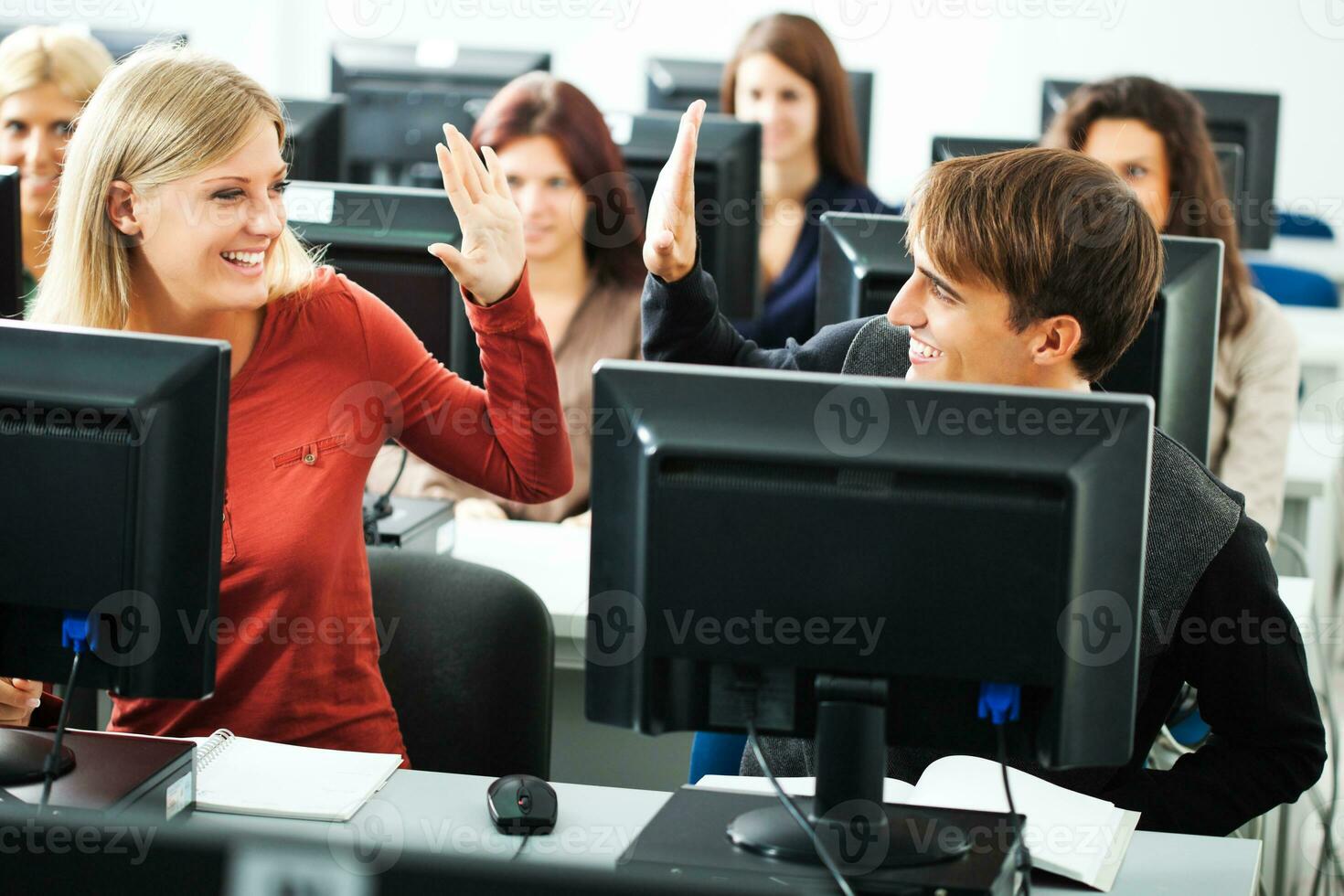 Students learning in a computer lab photo