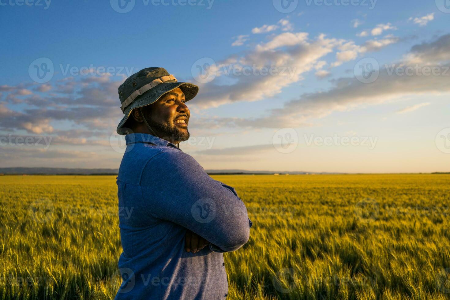 Afro farmer standing in a wheat field photo