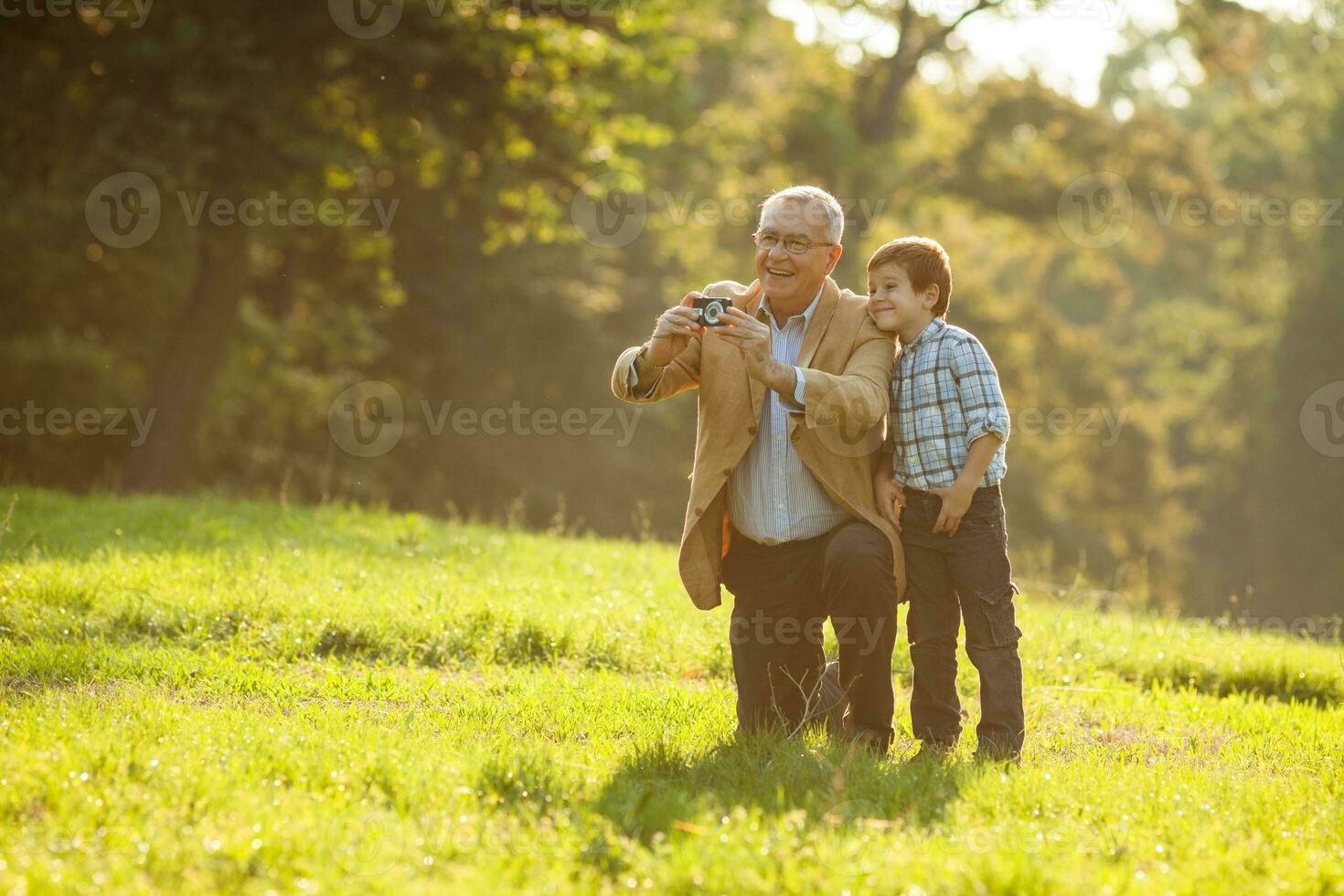A grandfather and his grandson spending time together outdoors photo