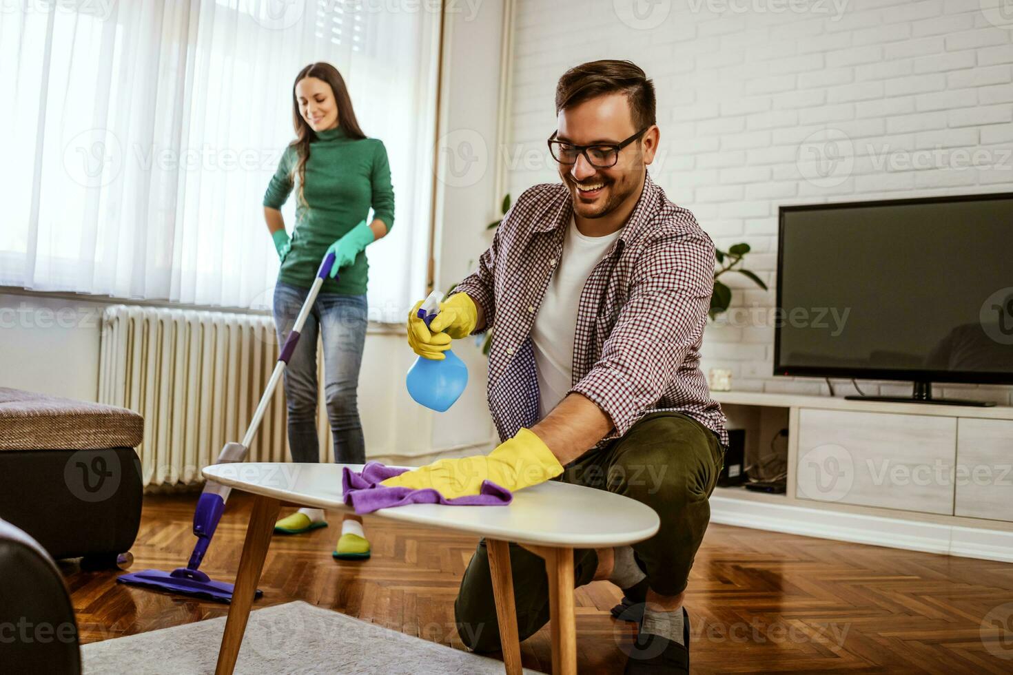 Young couple is exhausted from cleaning their apartment photo