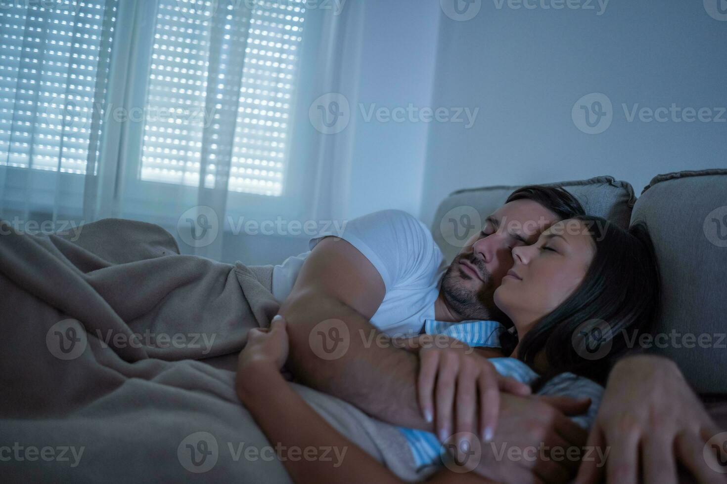 A young couple lying in bed photo