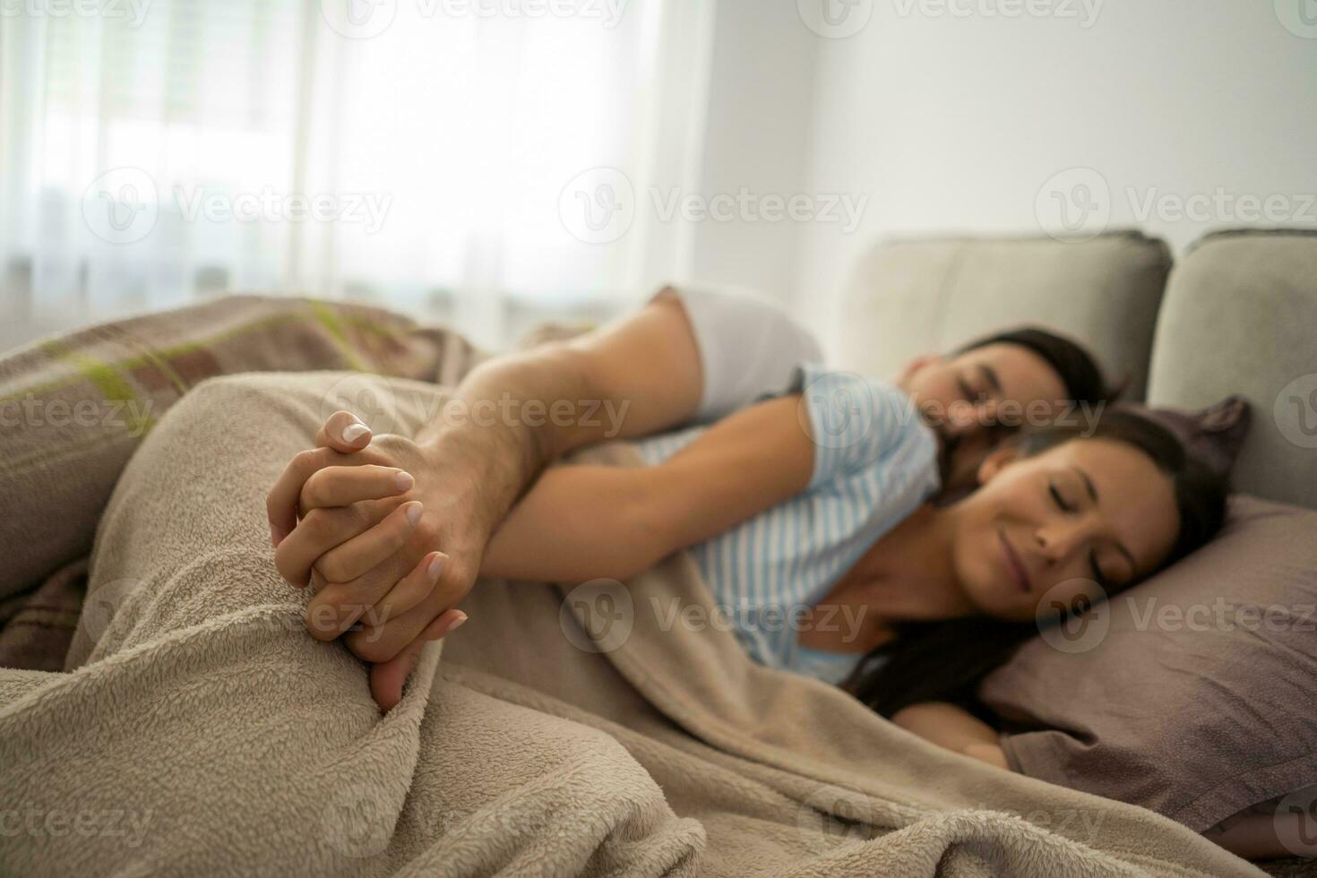A young couple lying in bed photo