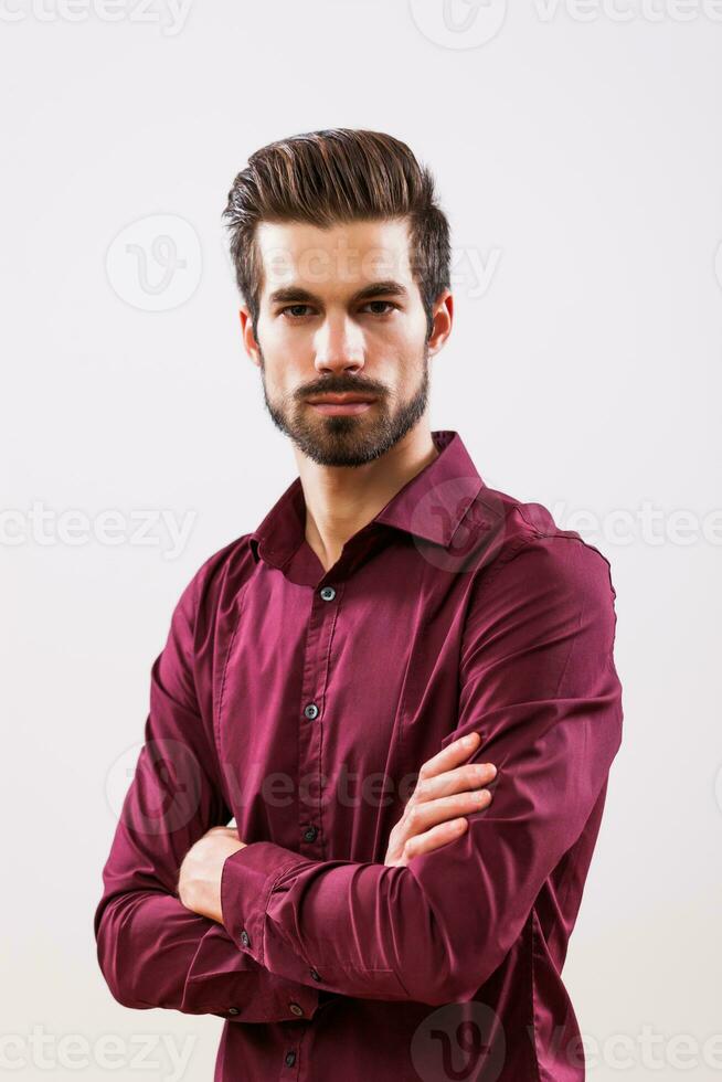 A serious man in a purple shirt photo