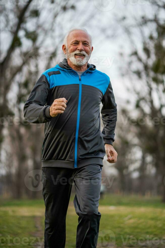 A senior man doing physical exercises photo