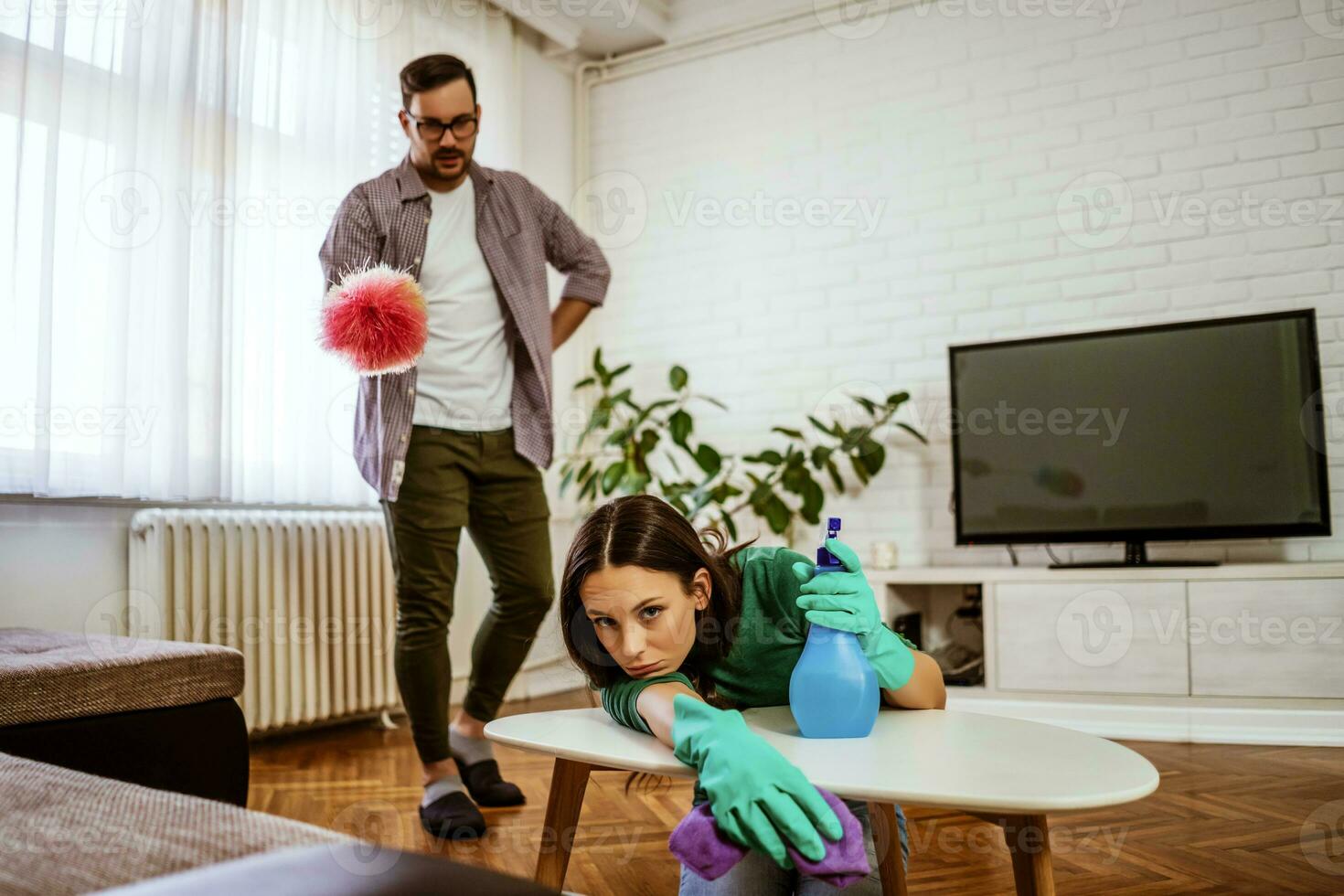 Young couple is cleaning their apartment photo