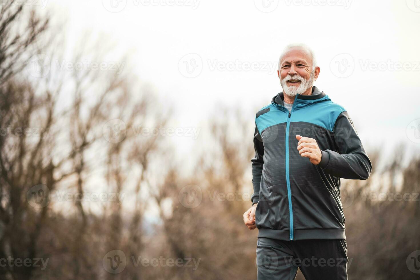 A senior man doing physical exercises photo