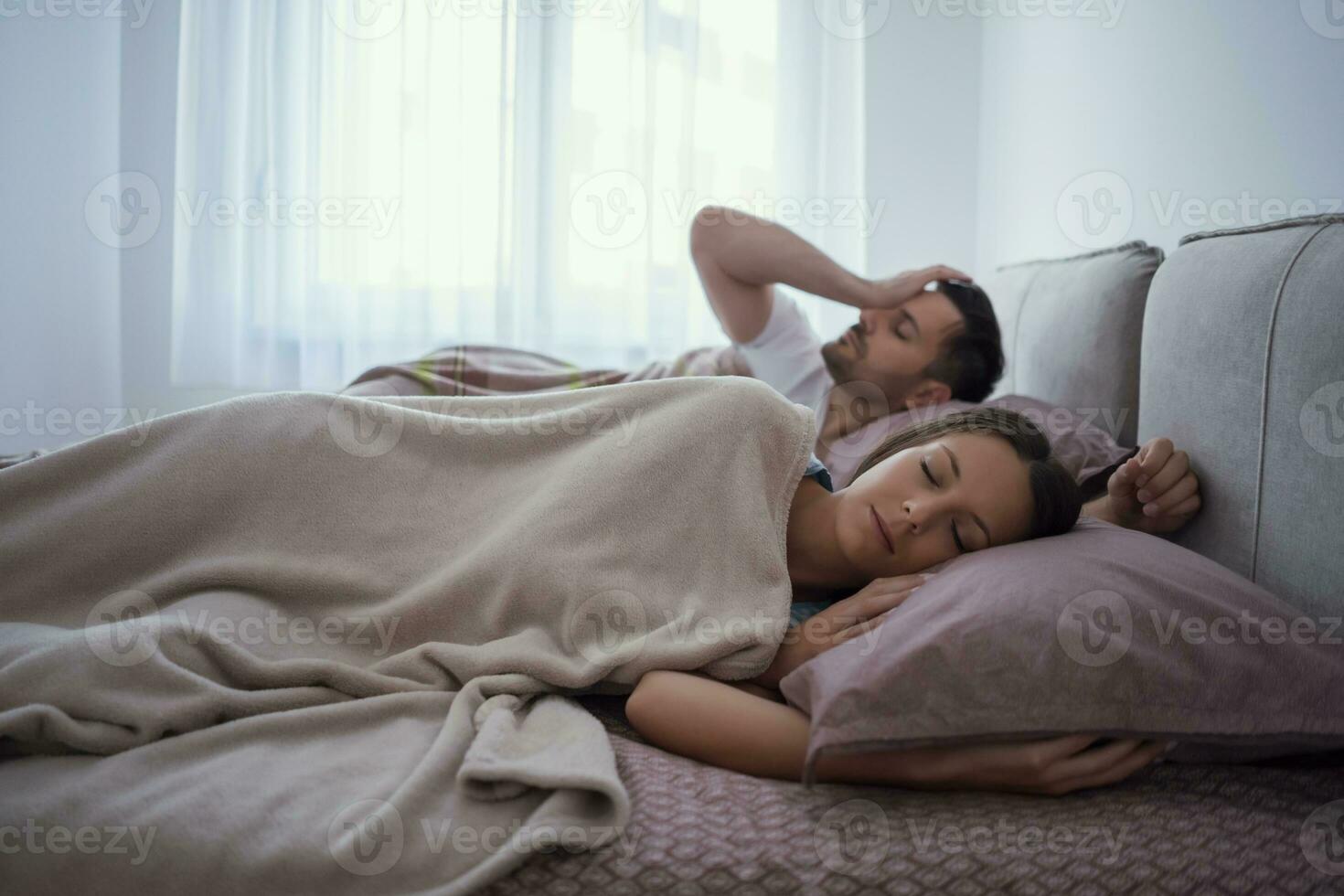 A young couple lying in bed photo