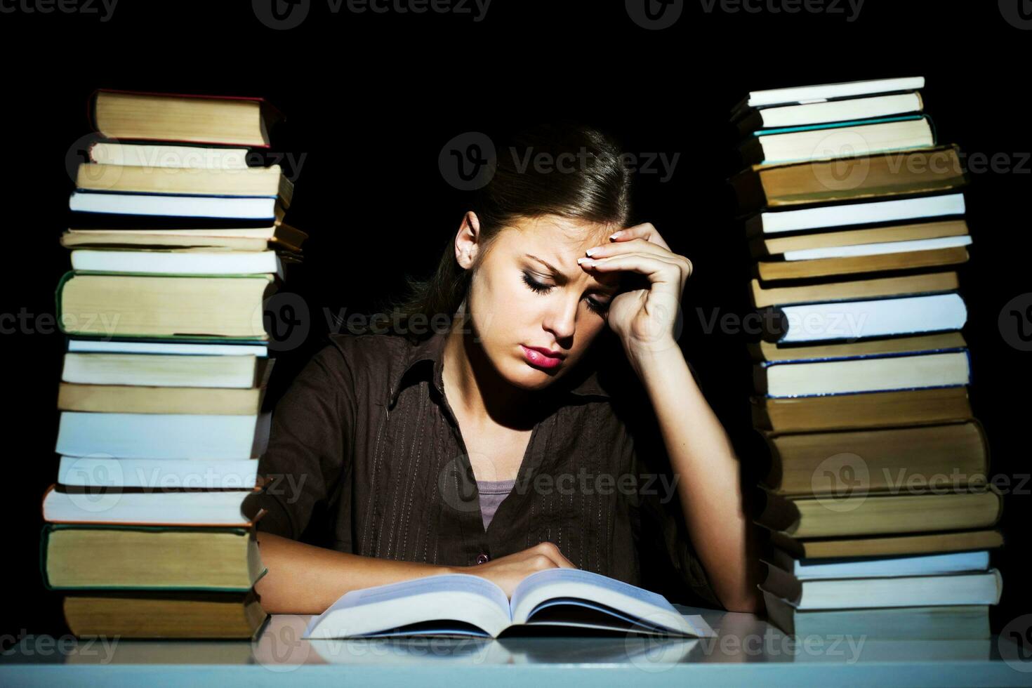 Portrait of a stressed woman with books photo