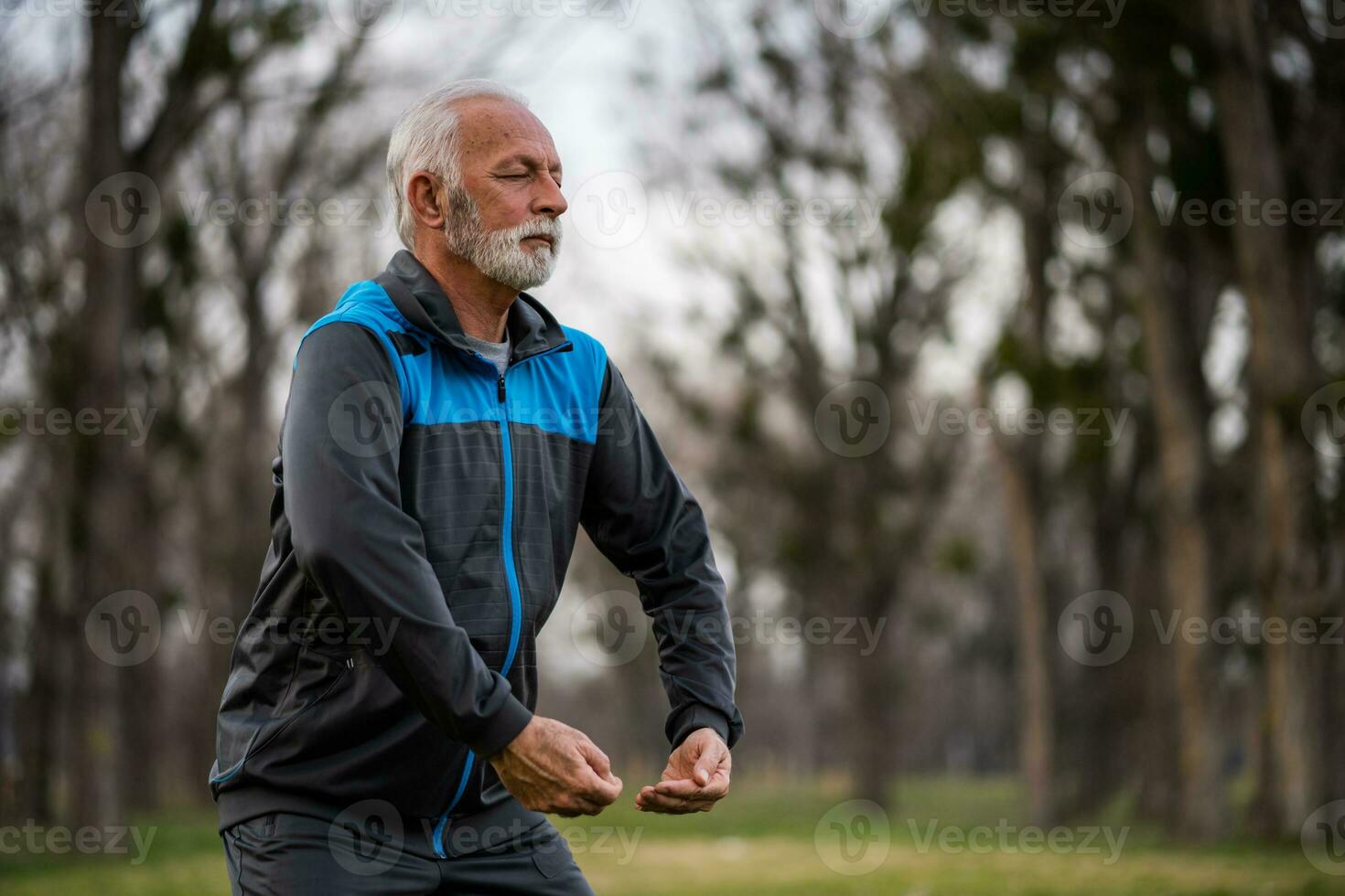A senior man doing physical exercises photo