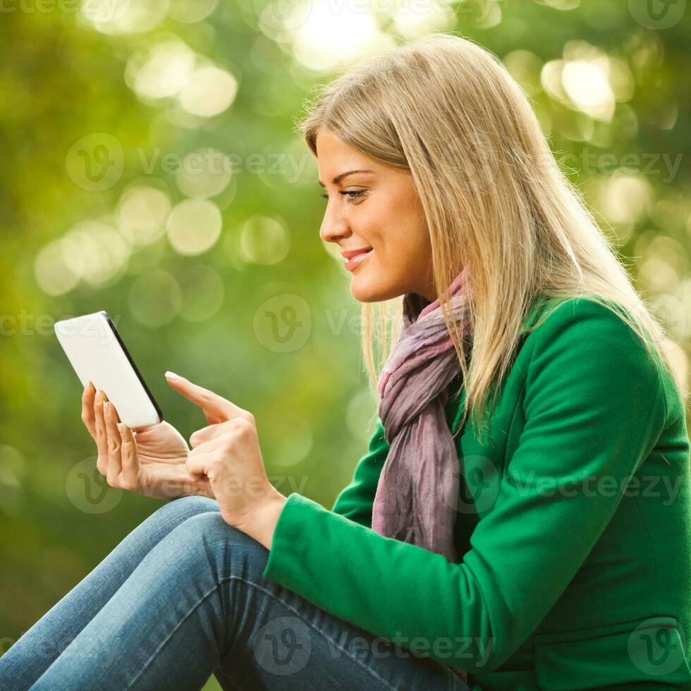 A woman reading a tablet photo