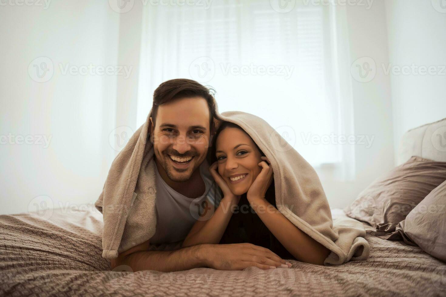 A young couple lying in bed photo