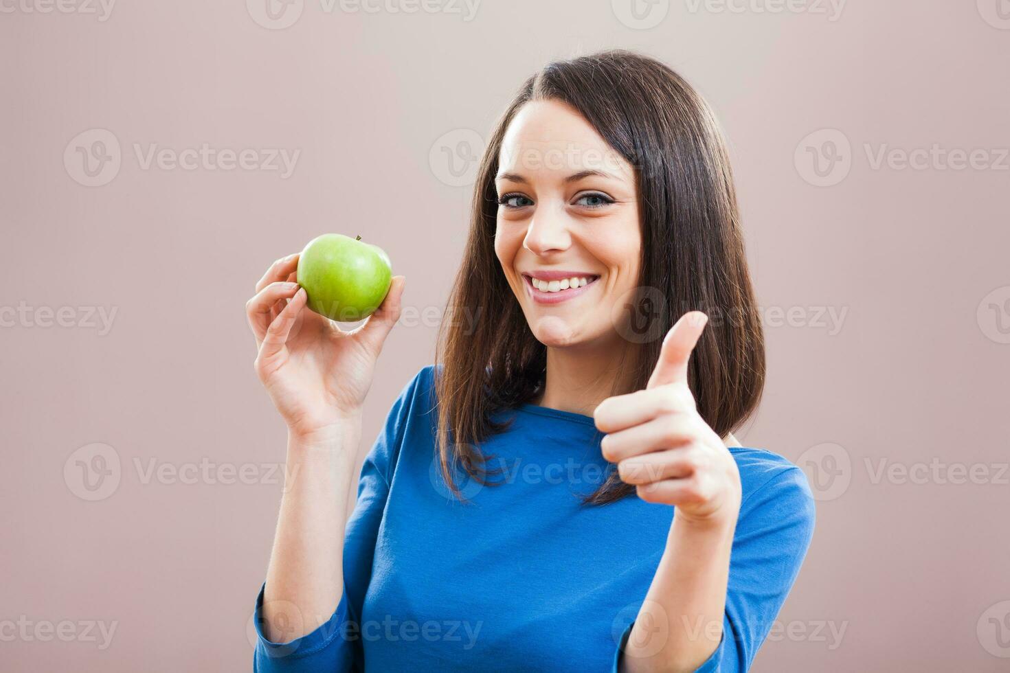 A woman eating an apple photo