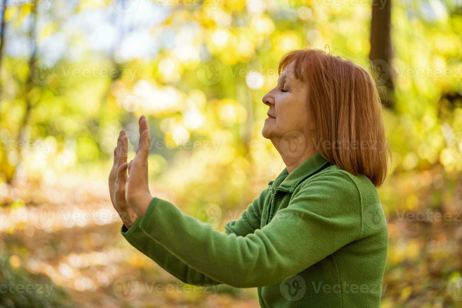 A senior woman doing physical exercises photo