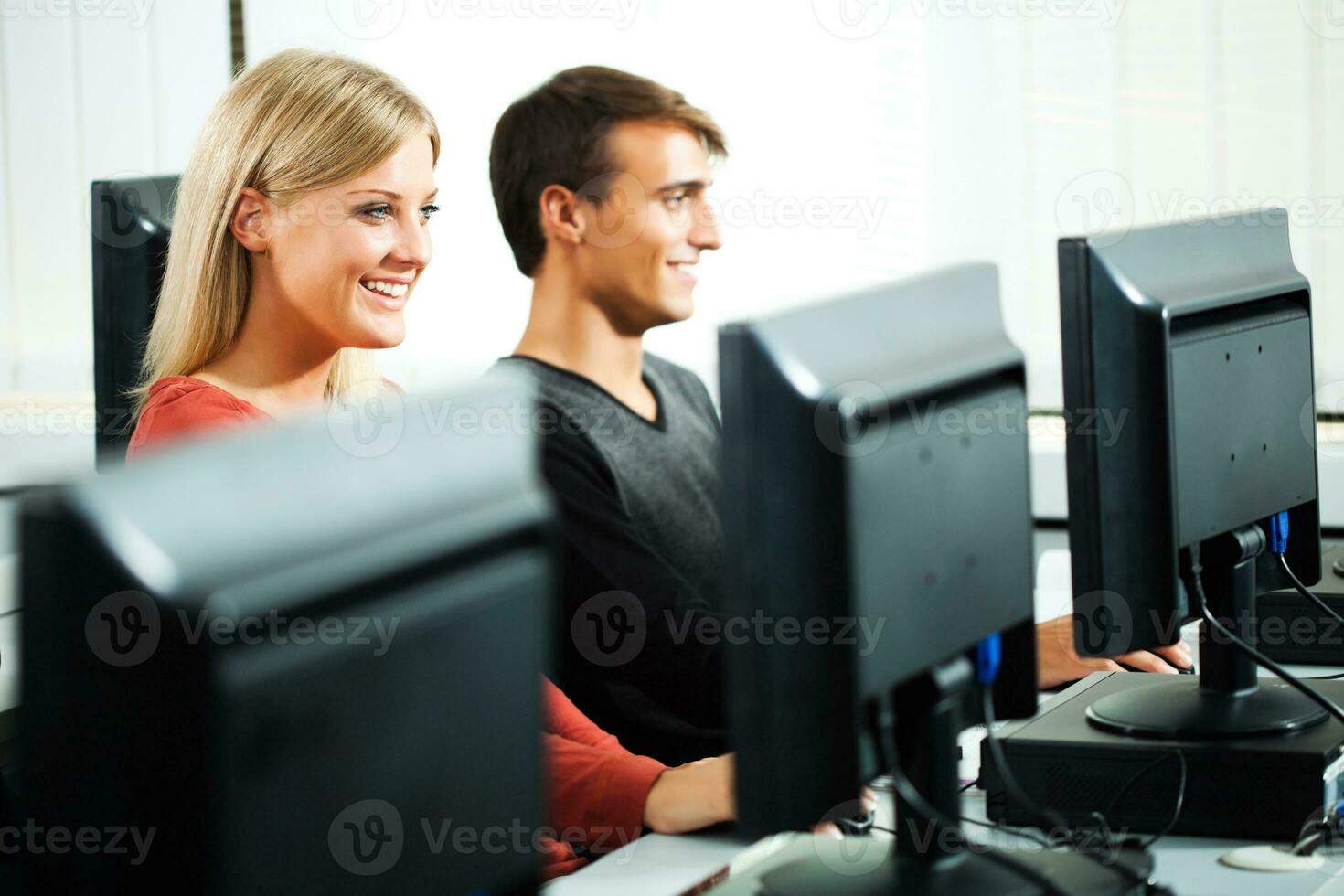 Students learning in a computer lab photo