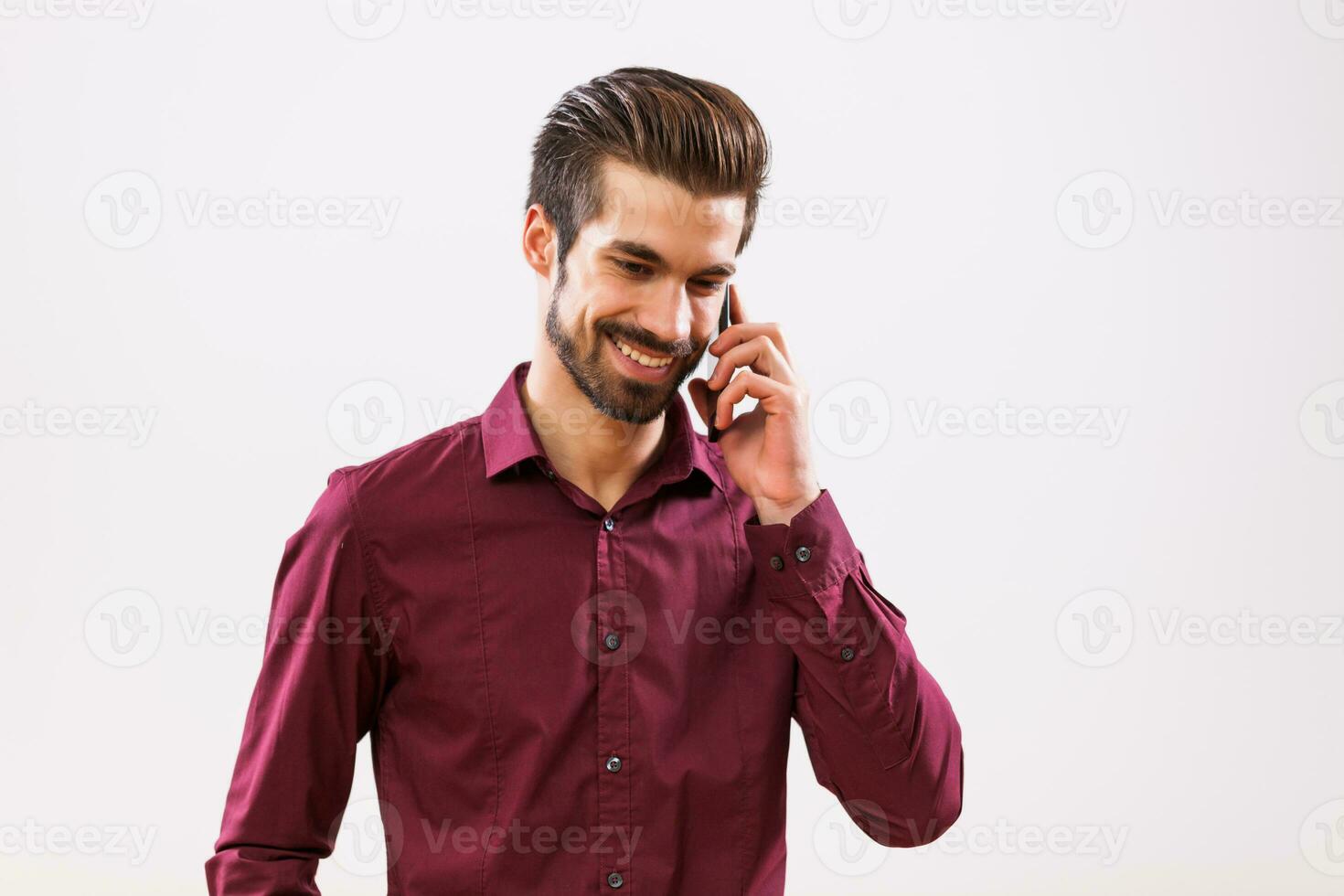 A man in a purple shirt on the phone photo